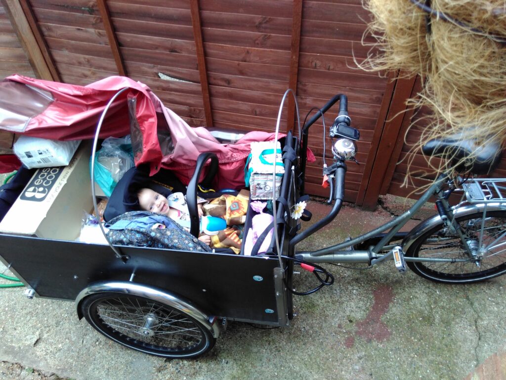 Cargo trike with shopping and baby on board.