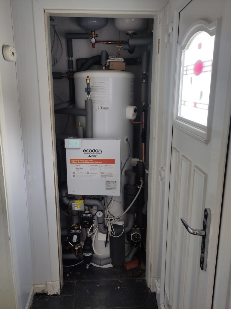 Hot water tank in place with pipes lagged.